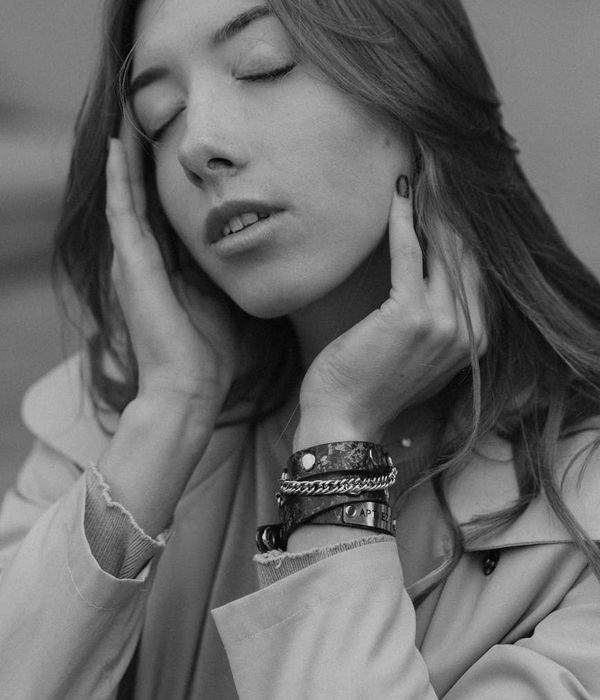 A person in a calm yoga pose in a dark room with golden light.